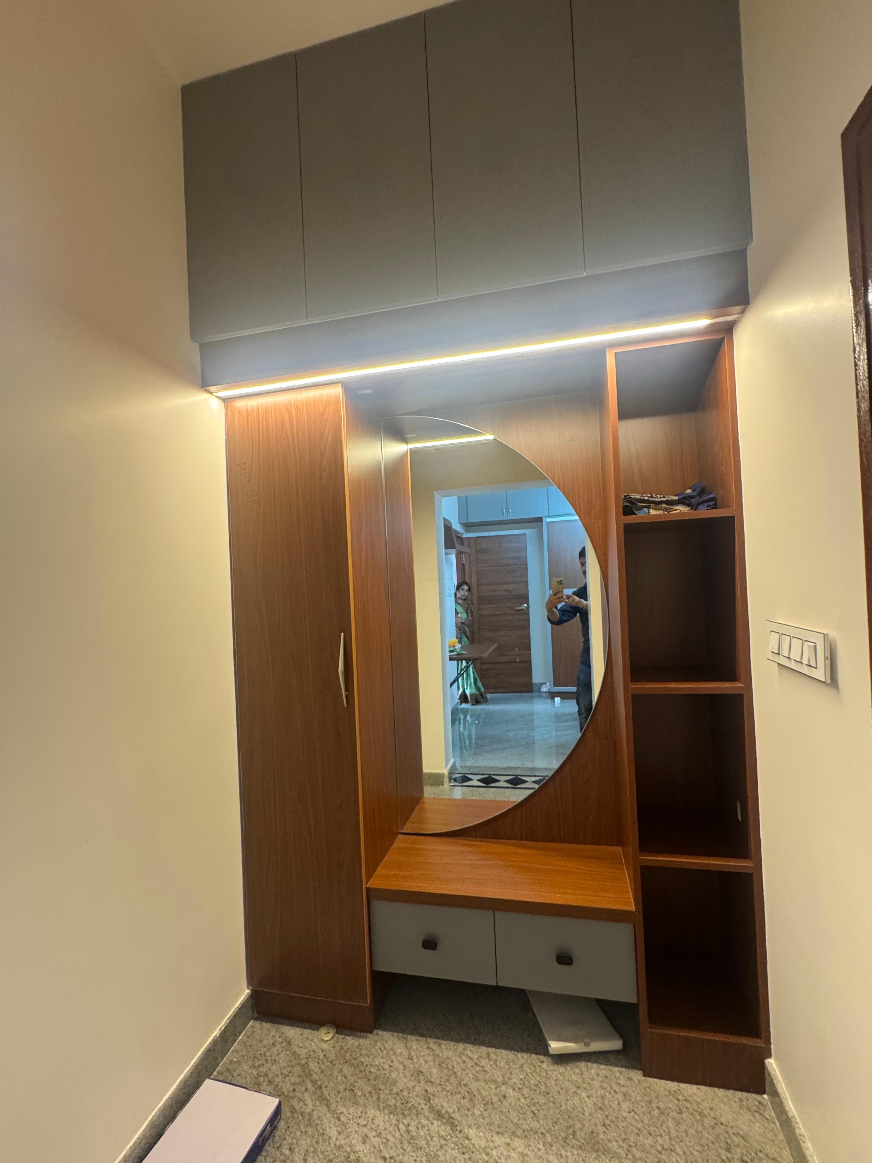 Bedroom dressing unit with round mirror and open shelves