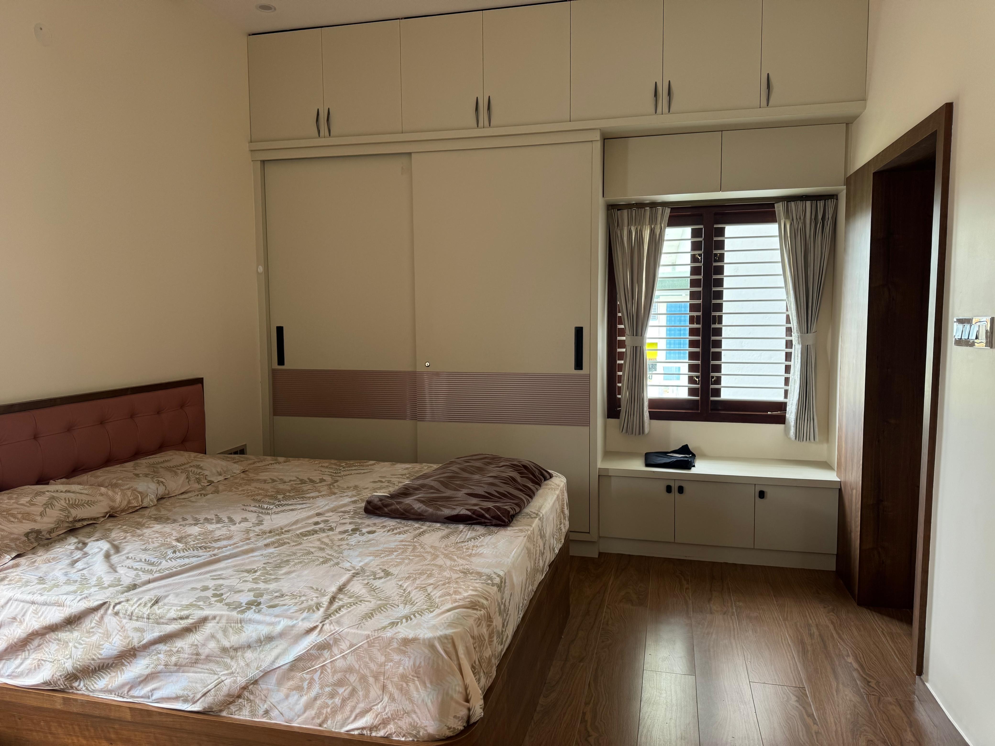 Bedroom wardrobe and window seating with neutral finishes