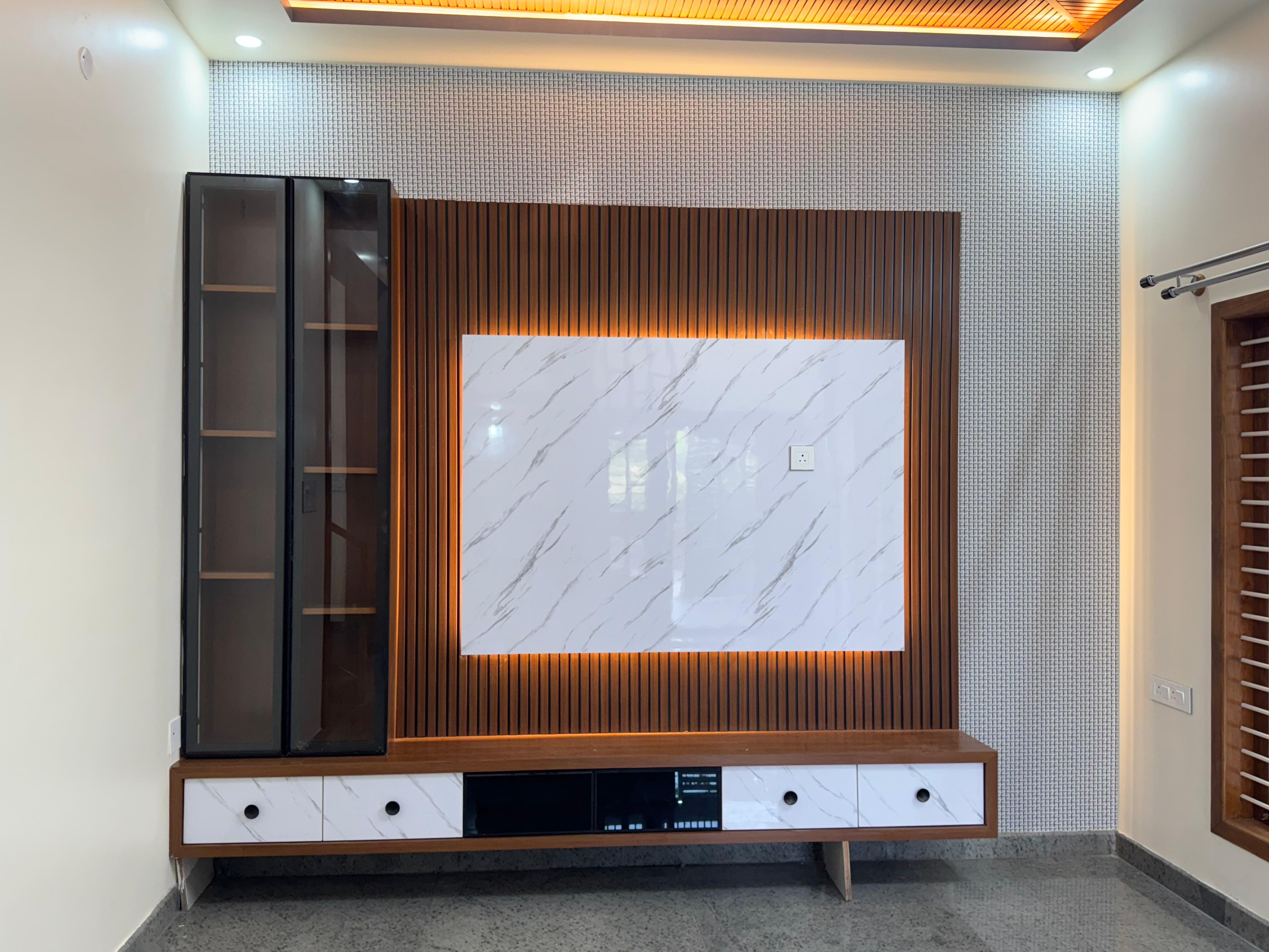 TV wall unit with fluted wood panel and warm lighting