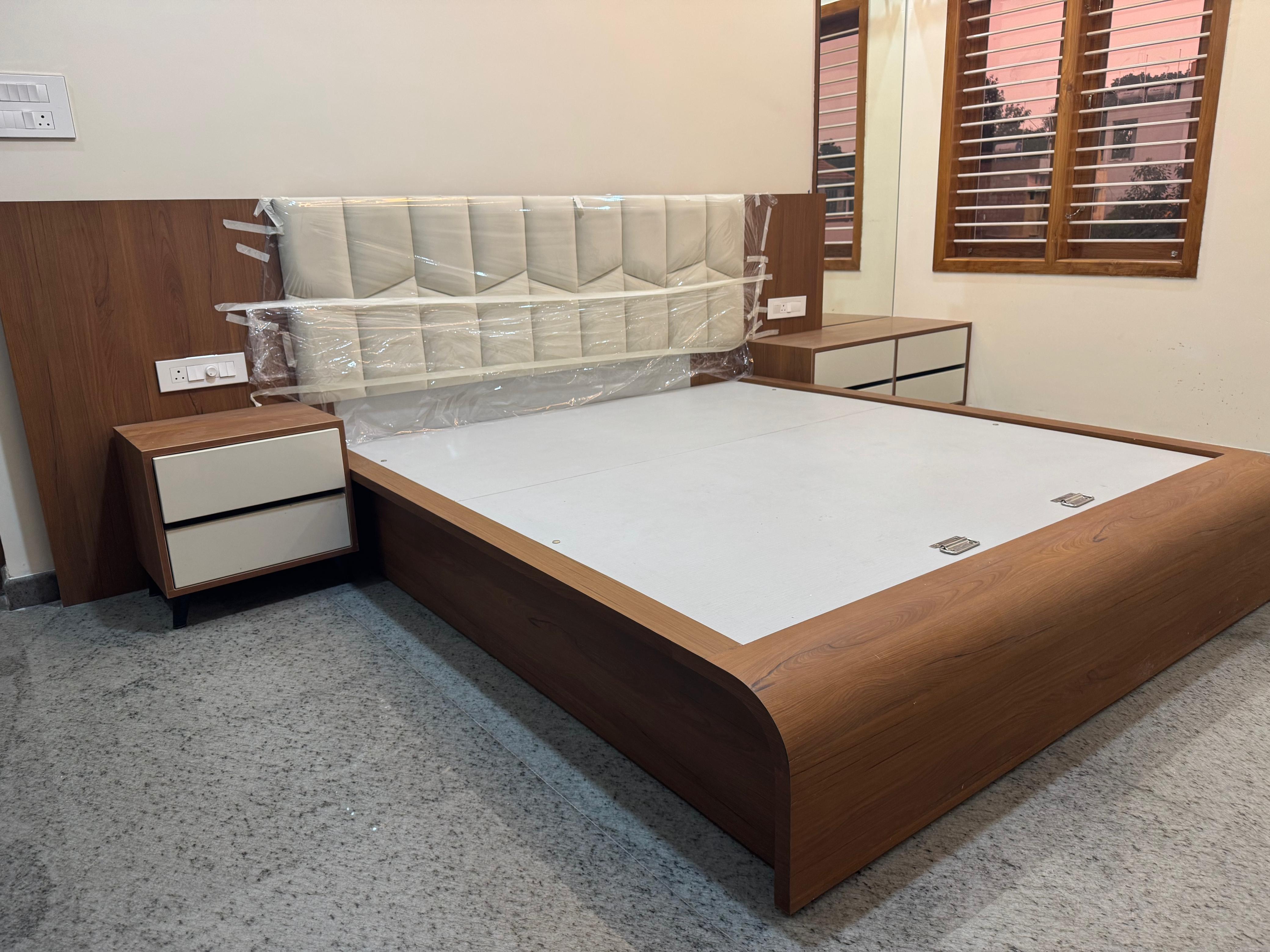 Wooden bed with upholstered headboard and side tables