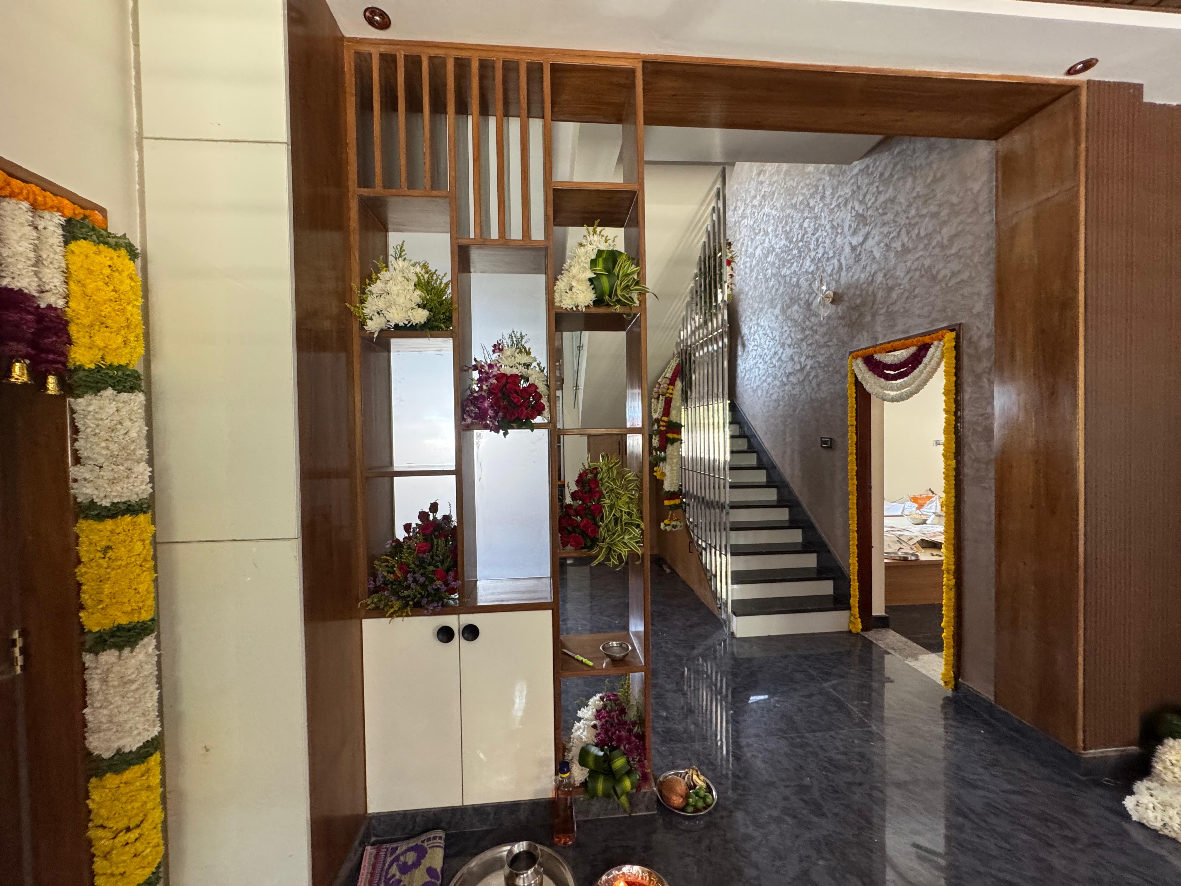 Entry foyer partition with floral display shelves